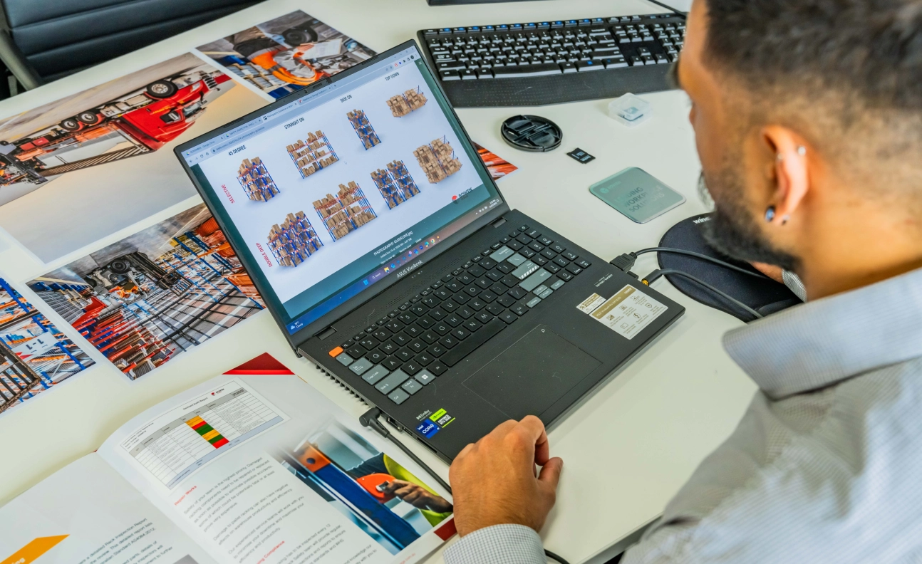 Worker analysing warehouse storage layouts on laptop for scalable and future-proof system design